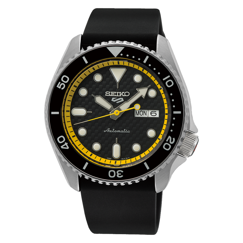 Seiko dive watch with a black dial, yellow inner bezel ring, and rubber strap.