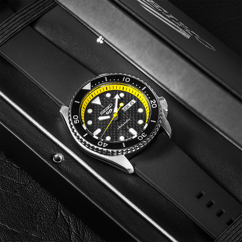 Stylish diver’s watch with a black face and yellow accents on the bezel.