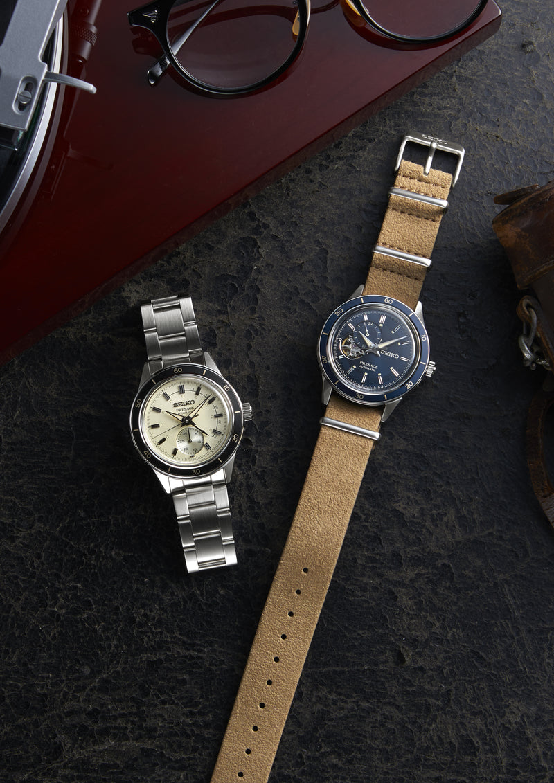 Two wristwatches with different styles of bands and faces.