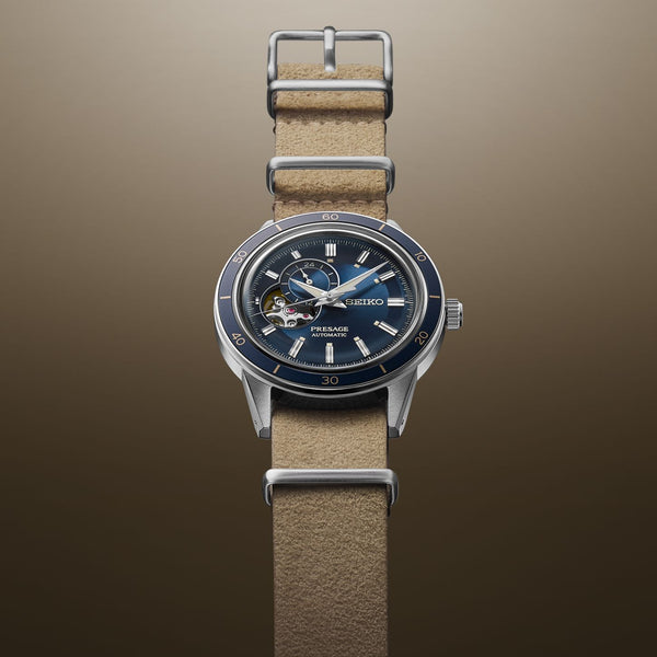 Wristwatch with a blue dial and tan leather strap.