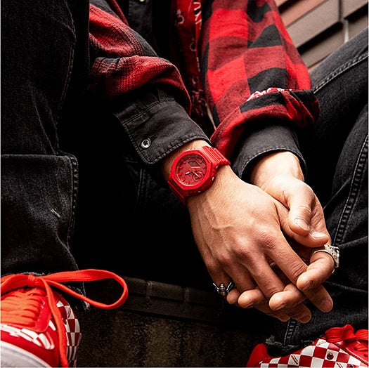 Red wristwatch worn on a person’s wrist.