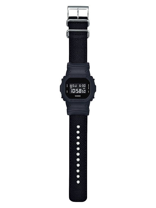 Digital wristwatch with a black rectangular face and fabric strap.