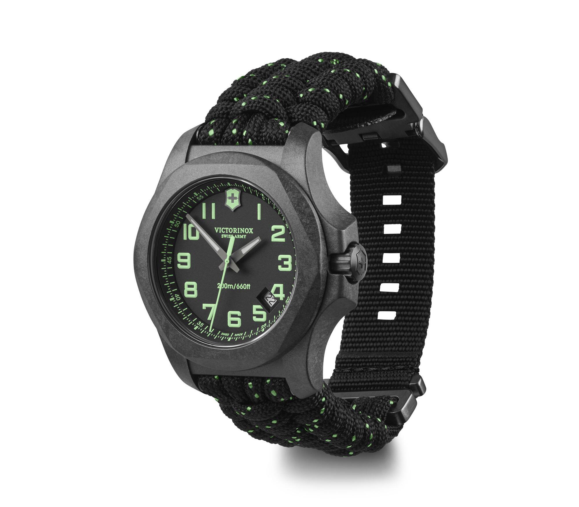 Rugged black wristwatch with green accents and a woven fabric strap.