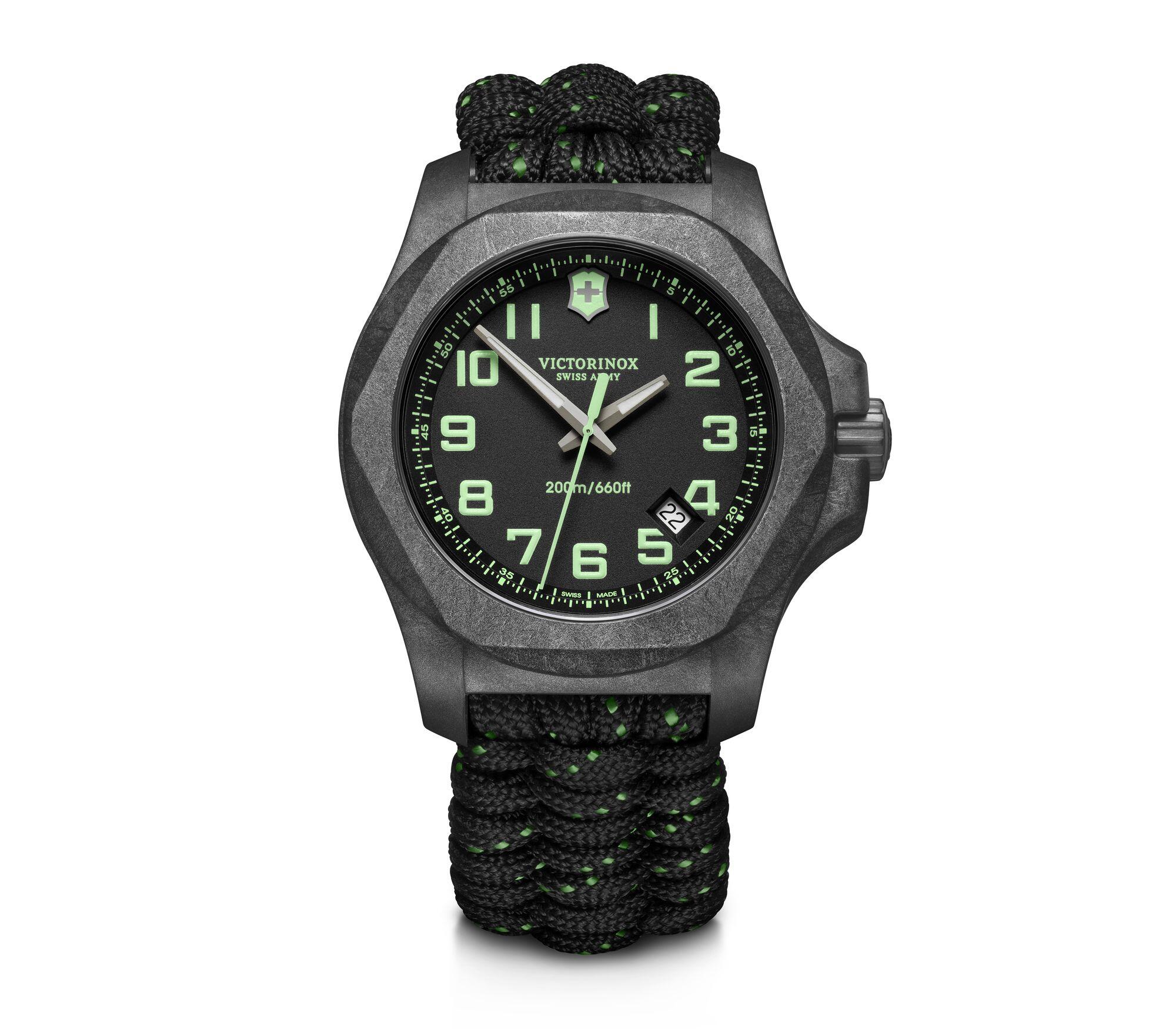 Rugged military-style wristwatch with a black dial and green luminous markings.