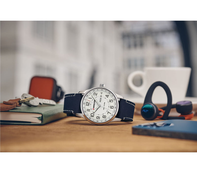 Analog wristwatch with a white face and blue fabric strap.