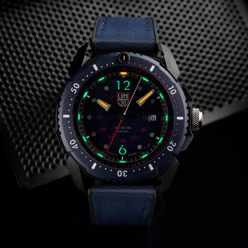 Luminous sports watch with a dark blue strap and colorful dial markings.