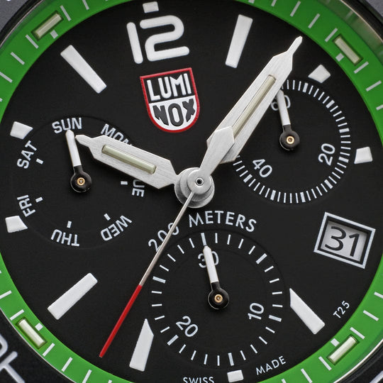 Luminox wristwatch face with a black dial, white markings, and a green bezel.