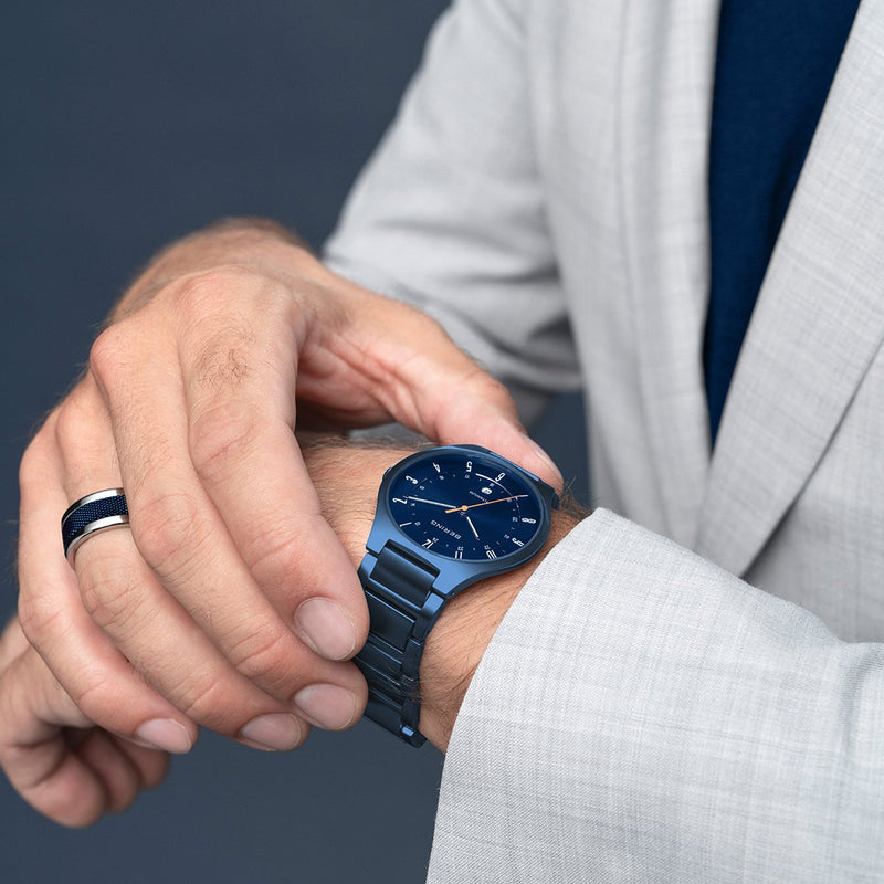 Elegant blue wristwatch with a metallic bracelet.