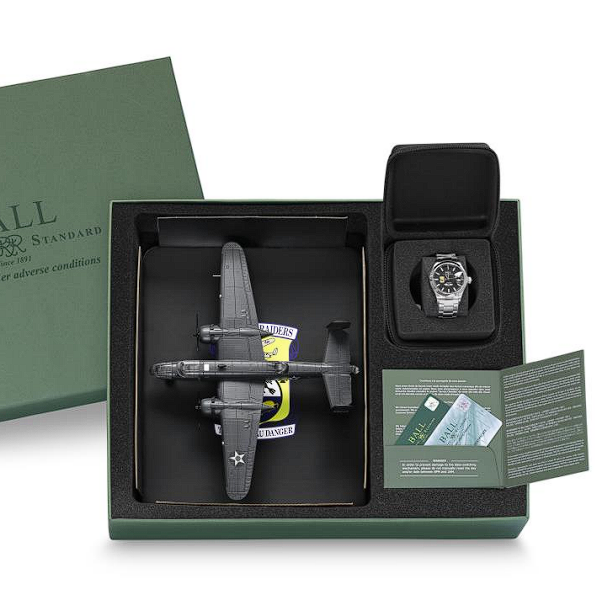 Model airplane alongside a wristwatch in a presentation box.