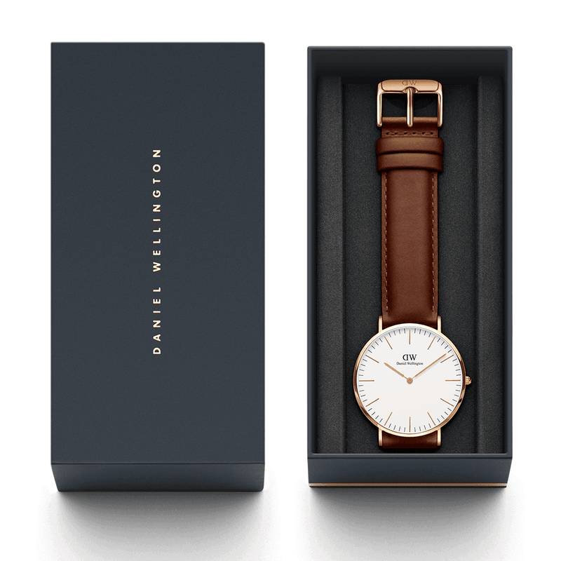 Elegant wristwatch with a brown leather strap and white face in a gift box.