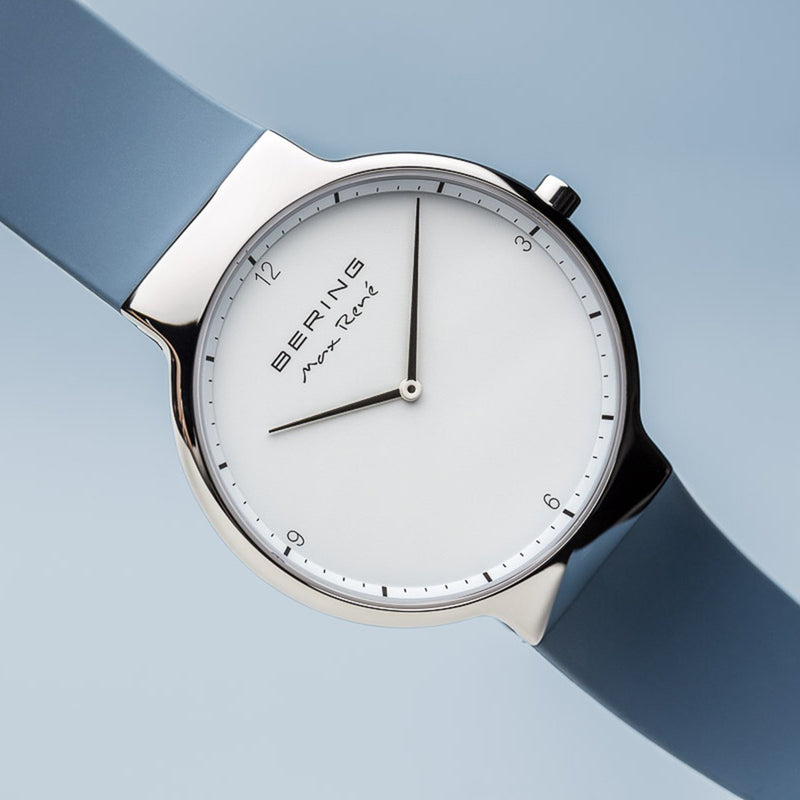 Sleek wristwatch with a minimalist white dial and light blue strap.