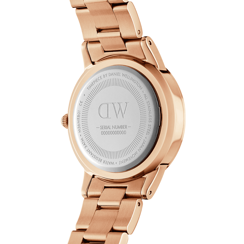 Rose gold wristwatch with a metal bracelet band and engraved caseback.