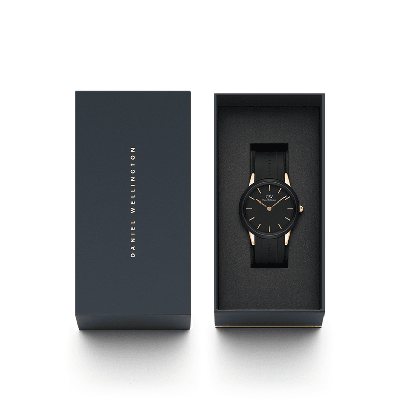 Sleek black wristwatch with gold accents in an open presentation box.