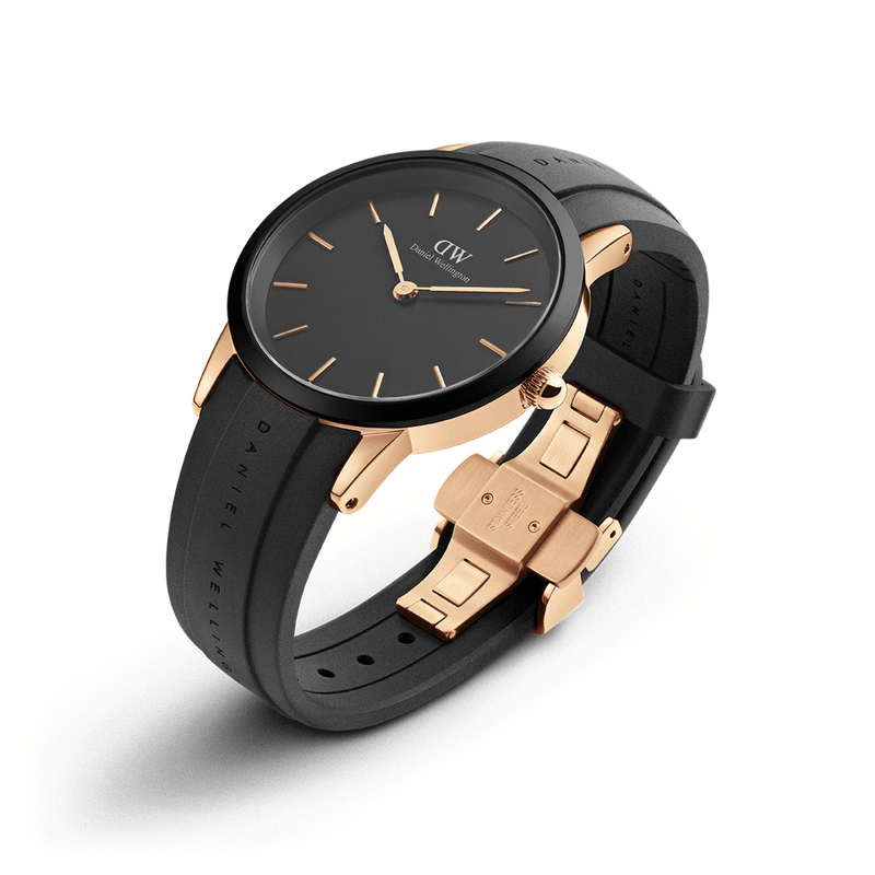 Elegant wristwatch with a black face and leather strap, accented by rose gold details.