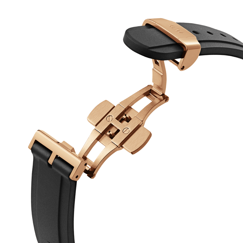 Watch clasp or buckle mechanism in rose gold tone with a black strap attached.