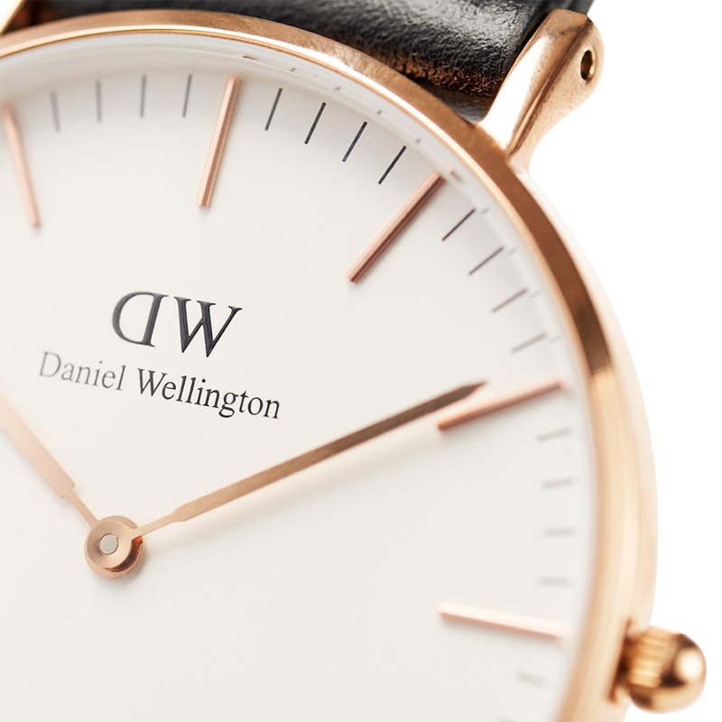 Elegant wristwatch with a rose gold case and white dial displaying the Daniel Wellington brand.