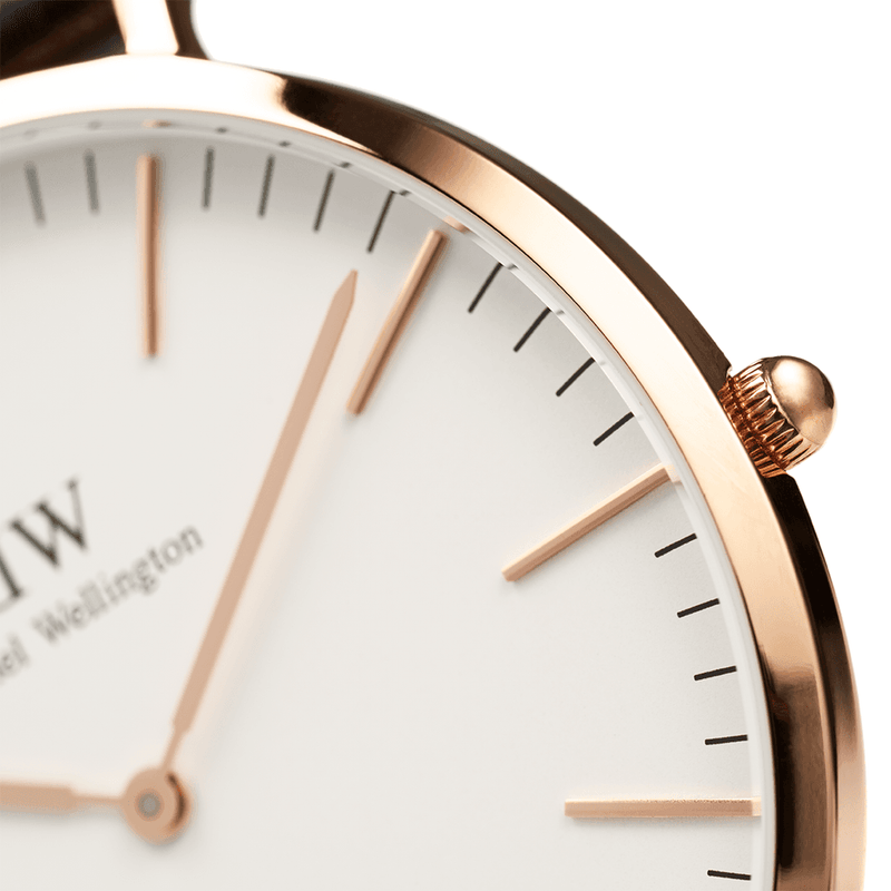 Elegant wristwatch with a rose gold bezel and white face.