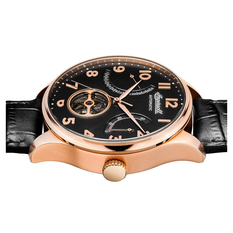 Luxury wristwatch with a black face, rose gold case, and leather strap.