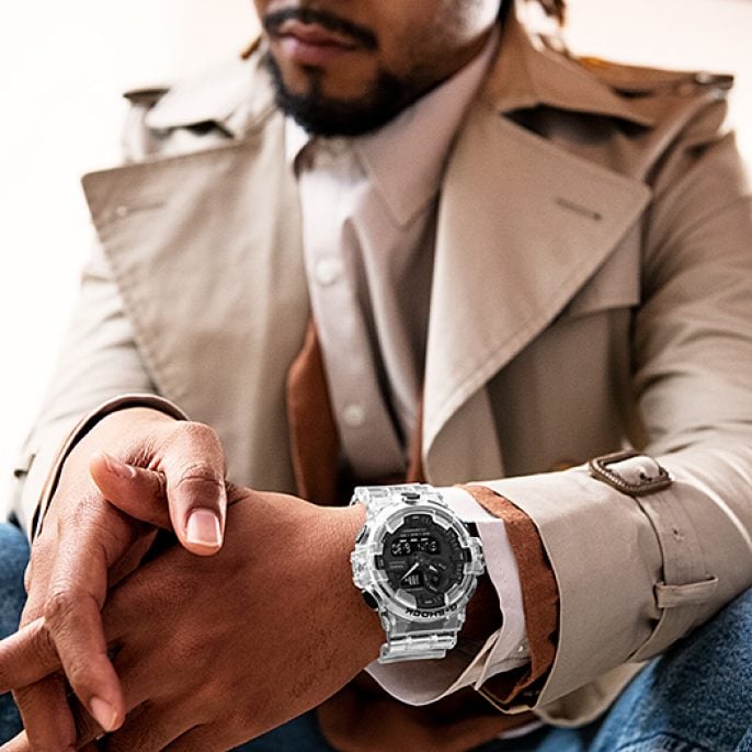 Stylish wristwatch with a clear or white band and dark face.
